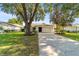 White brick ranch home with a two-car garage and a well-manicured lawn at 9145 Sw 90Th St, Ocala, FL 34481