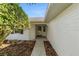Side entry to a white brick home with a walkway and landscaping at 9145 Sw 90Th St, Ocala, FL 34481