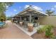 Covered outdoor bar area with seating and a TV at 3396 Nw 55Th Ct, Ocala, FL 34482