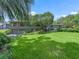 Large backyard with lush grass and mature trees at 1923 Se 7Th St, Ocala, FL 34471