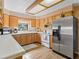 Kitchen features stainless steel appliances and light wood cabinets at 1923 Se 7Th St, Ocala, FL 34471