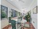 Sunroom features a glass-top table and seating for four at 1923 Se 7Th St, Ocala, FL 34471