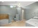 Modern bathroom with a walk-in shower, bathtub, and tile accents at 2811 Se 14Th St, Ocala, FL 34471