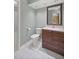 Clean bathroom with brown vanity and white tile floors at 2811 Se 14Th St, Ocala, FL 34471