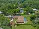 Aerial view of home with pool in a wooded area at 2811 Se 14Th St, Ocala, FL 34471