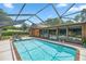 Relaxing screened pool and spa with brick coping at 2811 Se 14Th St, Ocala, FL 34471