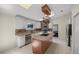 Modern kitchen with island, stainless steel appliances, and pot rack at 2811 Se 14Th St, Ocala, FL 34471