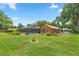 Home with a large backyard, lush lawn, and screened pool at 2811 Se 14Th St, Ocala, FL 34471