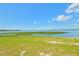 Expansive lakefront view with grassy area and clear sky at 25155 Ne 142Nd Pl # Lot 212, Salt Springs, FL 32134