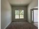 Dining room with chandelier and large window overlooking yard at 11600 Sw 55Th Ave, Ocala, FL 34476