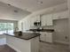 Modern kitchen with white cabinets, stainless steel appliances, and an island at 11600 Sw 55Th Ave, Ocala, FL 34476