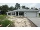 One-story home with gray siding, black shutters, and two-car garage at 11600 Sw 55Th Ave, Ocala, FL 34476