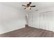 Spacious bedroom with wood-look floors and ceiling fan at 46 Lake Court Loop, Ocala, FL 34472