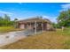 Pink single story home with carport and fenced yard at 46 Lake Court Loop, Ocala, FL 34472