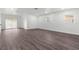 Bright living room featuring wood-look floors and sliding glass doors at 46 Lake Court Loop, Ocala, FL 34472