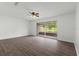 Living room with wood-look floors and sliding glass doors to patio at 46 Lake Court Loop, Ocala, FL 34472