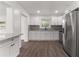 Bright kitchen boasts white cabinets and granite countertops at 46 Lake Court Loop, Ocala, FL 34472