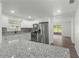 Renovated kitchen featuring granite island and stainless steel appliances at 46 Lake Court Loop, Ocala, FL 34472
