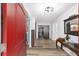 Bright entryway with red door and hardwood floors at 5240 Se 17Th St, Ocala, FL 34471