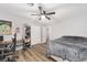 Spacious bedroom with a large bed, built-in shelving, and wood-look floors at 5240 Se 17Th St, Ocala, FL 34471