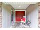 Inviting front porch with red door and rocking chair at 5240 Se 17Th St, Ocala, FL 34471