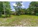 House nestled in a large backyard with trees at 5240 Se 17Th St, Ocala, FL 34471