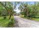 Ranch home with a long driveway and lush landscaping at 5240 Se 17Th St, Ocala, FL 34471