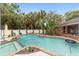 Inviting kidney-shaped pool with a spa and lush landscaping at 5240 Se 17Th St, Ocala, FL 34471