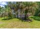 Spacious backyard with lush landscaping and a bench at 5240 Se 17Th St, Ocala, FL 34471