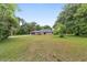 Ranch home with a long driveway and mature trees at 5240 Se 17Th St, Ocala, FL 34471