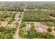 An aerial view shows the home's location in a wooded neighborhood at 5240 Se 17Th St, Ocala, FL 34471