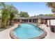 Inviting kidney-shaped pool with a spa and lush landscaping at 5240 Se 17Th St, Ocala, FL 34471