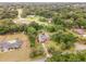 Aerial view of a house with a pool in a wooded area at 5240 Se 17Th St, Ocala, FL 34471