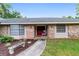Brick home with red front door and landscaping at 5240 Se 17Th St, Ocala, FL 34471
