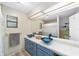 Bathroom with double vanity, large mirror, and updated fixtures at 5240 Se 17Th St, Ocala, FL 34471