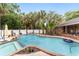 Inviting kidney-shaped pool with a spa and lush landscaping at 5240 Se 17Th St, Ocala, FL 34471