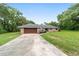 Brick ranch home with a wooden garage door at 5240 Se 17Th St, Ocala, FL 34471