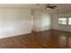Spacious living room with light wood laminate flooring and ceiling fan at 24822 Pine Hl, Leesburg, FL 34748