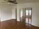 Primary bedroom with mirrored closet doors and wood flooring at 24822 Pine Hl, Leesburg, FL 34748