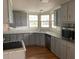 Gray kitchen with ample cabinetry, granite countertops, and stainless steel appliances at 24822 Pine Hl, Leesburg, FL 34748