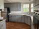 Gray kitchen with ample cabinetry, granite countertops, and stainless steel appliances at 24822 Pine Hl, Leesburg, FL 34748
