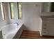 Bathroom with soaking tub, updated vanity, and stylish flooring at 24822 Pine Hl, Leesburg, FL 34748
