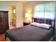 Bedroom with a double bed, wooden dresser, and ensuite bathroom at 10765 Sw 62Nd Ter, Ocala, FL 34476