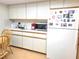 Kitchen with white cabinets, a microwave, and a refrigerator at 10765 Sw 62Nd Ter, Ocala, FL 34476