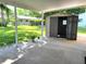 Covered patio with storage shed and grassy backyard at 10765 Sw 62Nd Ter, Ocala, FL 34476