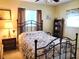Bedroom with a double bed, nightstand, and bookcase at 10765 Sw 62Nd Ter, Ocala, FL 34476