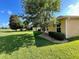 Side yard of a house with lush green grass and landscaping at 16026 Sw 14Th Avenue Rd, Ocala, FL 34473