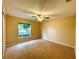 Spacious bedroom with ceiling fan and window at 16026 Sw 14Th Avenue Rd, Ocala, FL 34473