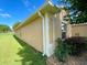 Side view of a tan house with well-maintained landscaping at 16026 Sw 14Th Avenue Rd, Ocala, FL 34473