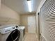 Bright laundry room with washer, dryer, and ample shelving at 16026 Sw 14Th Avenue Rd, Ocala, FL 34473